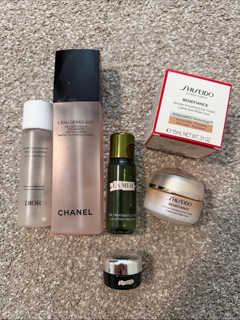 variety of empty skin care jars and bottles, La Mer, Chanel, Dior, Shiseido